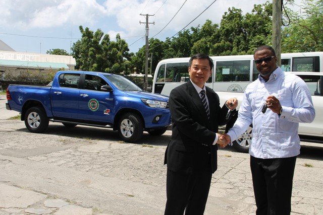 (L-r) Republic of China (Taiwan) Resident Ambassador to St. Kitts and Nevis His Excellency George Gow Wei Chiou, officially hands over the keys to two brand new Toyota trucks to Deputy Premier and Minister of Health Hon. Mark Brantley, at Government Headquarters in Charlestown on August 30, 2016, for use at the Nevis Solid Waste Management Authority and the Port Health Unit